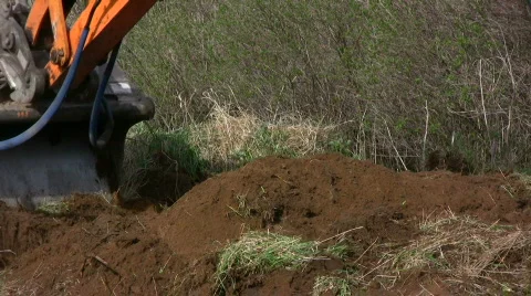 Backhoe dig in a garden Stock Footage 704419