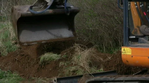 Backhoe dig in a garden Stock Footage 704446