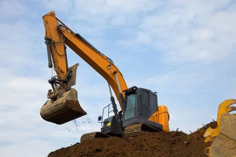 Backhoe digging hydraulic shovel on construction site earth mover excavator.. Stock-Fotos