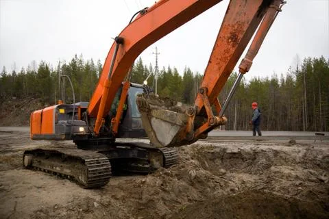 Backhoe digging trench Stock Photos