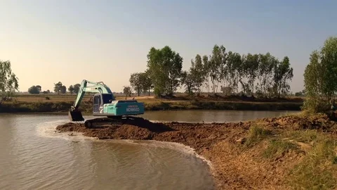 Backhoe dredging the river in the countryside. Stock Footage 85045716