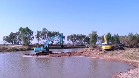 Backhoe dredging the river in the countryside. Stock Footage 85047113