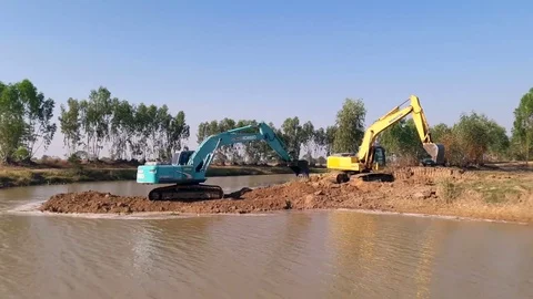 Backhoe dredging the river in the countryside. Stock Footage 85049481