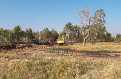 Backhoe is dredging the river for use in the dry season. Stock Photos
