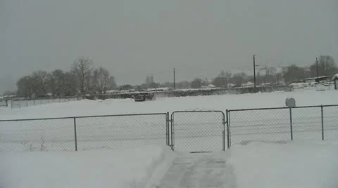 Backhoe driving left to right during winter Stock Footage 18172049