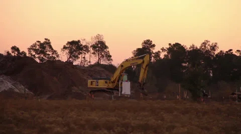 Backhoe Excavating in the Morning Video stock 22461406