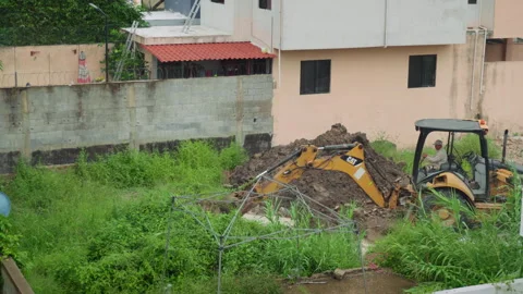 Backhoe Excavator Working on Overgrown Terrain Cloudy Day Stock Footage 342663926