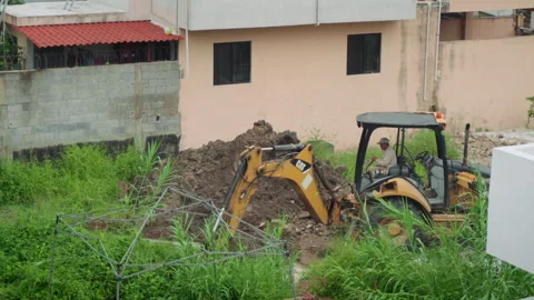 Backhoe Excavator Working on Overgrown Terrain Cloudy Day Stock Footage 342663931