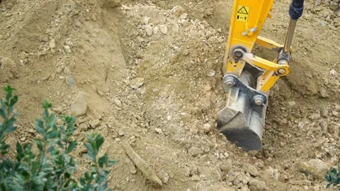 A backhoe executing a soil dumping operation Stock Footage 285262641