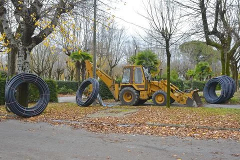 Backhoe Loader and Flexible Drain Pipes Stock Photos
