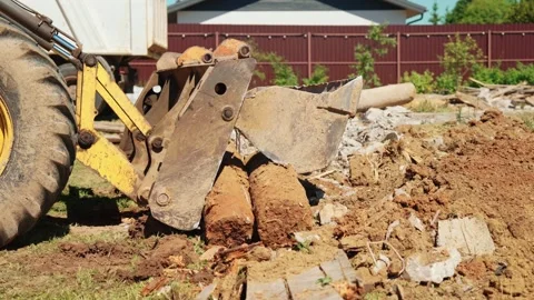 Backhoe Loader Bucket Carrying Large Concrete Foundation Block Stock Footage 337848864