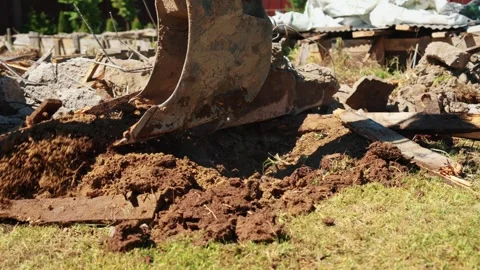 Backhoe Loader Bucket Spreading Soil Over Demolition Debris Stock Footage 337830675