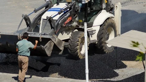 Backhoe loader carries out road repair, utilities, construction and ground work  Stock Footage 122261841
