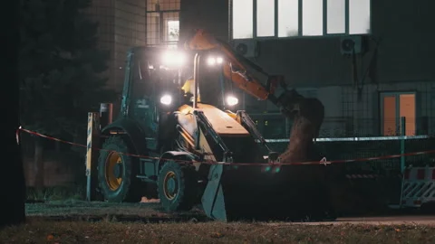 Backhoe Loader Digging with Bright Headlights at Night | Excavator Front Bucket Stock Footage 344076766