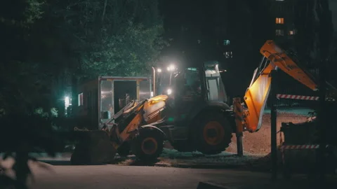 Backhoe Loader Digging Trench at Night | Excavator Arm Lifting Bucket for Water Stock Footage 344012854