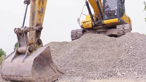 Backhoe loader on a heap of gravel Stock Footage 284153677