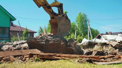 Backhoe Loader Lifting Concrete Slab With Exposed Rebar Stock Footage 337830668