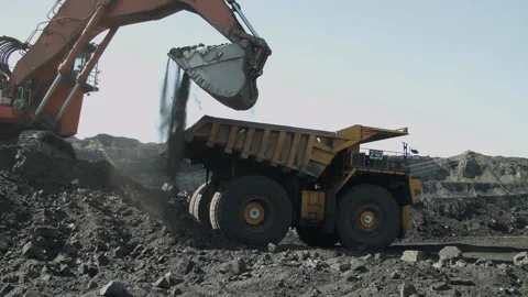 Backhoe loader loading dumper truck Stock Footage 205242074