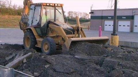 Backhoe Loader Pushing Pavement Stock Footage 91609
