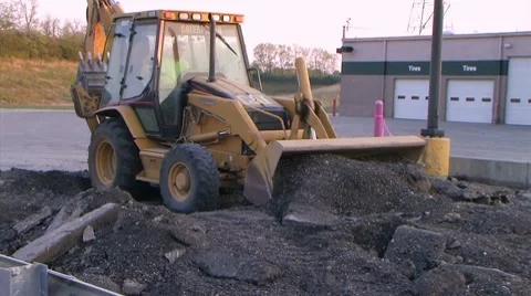 Backhoe Loader Pushing Pavement Stock Footage 8599148