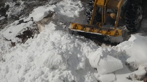 Backhoe loader scraper snow by claw bucket plow, tractor move Stock Footage 171919311