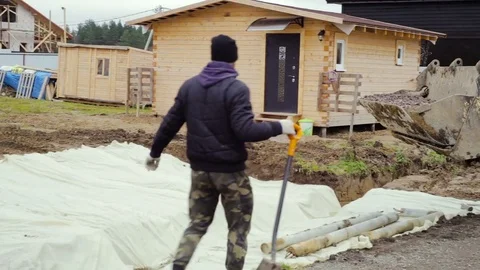 Backhoe loader unloads rubble at a construction site. Stock Footage 73042982