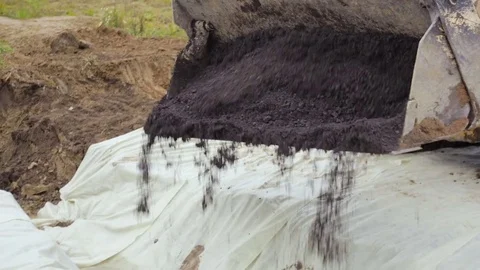 Backhoe loader unloads rubble at a construction site. Stock Footage 73043004
