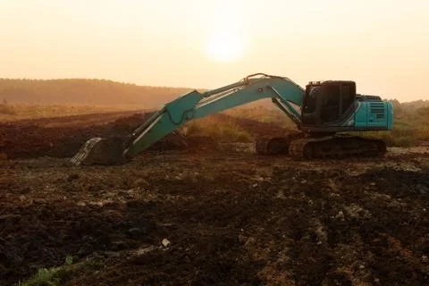 Backhoe machine soil excavation for construction industry development Stock Photos