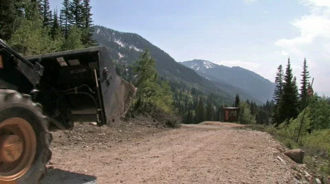 Backhoe on mountain road construction M HD Stock Footage 141423