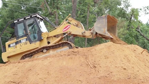 Backhoe moving dirt Stock Footage 81750699
