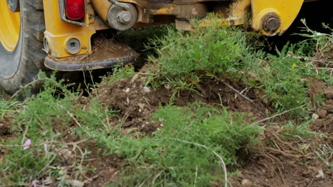 Backhoe operating in a Land on The Nature. Stabilizer Arm elevates and Red light Stock Footage 153655738