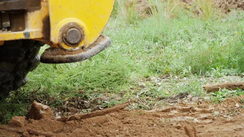 Backhoe operating in a Land on The Nature.  Stabilizer Arm elevates Video stock 153656000