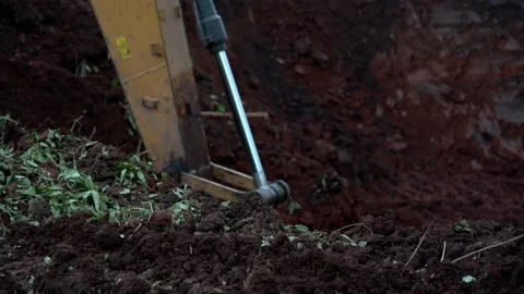 Backhoe or excavator working on land of countryside, excavator dig soil in field 库存影片 158486334