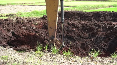 Backhoe or excavator working on land of countryside, excavator dig soil in field 스톡 동영상 158486478