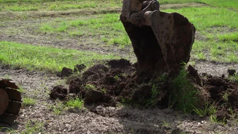 Backhoe or excavator working on land of countryside, excavator dig soil in field 動画素材 158486699