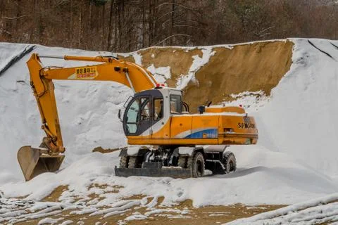 Backhoe in the snow. Stock Photos