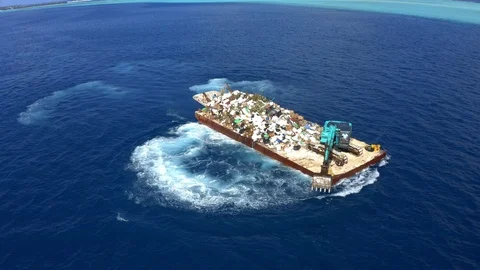 Backhoe on a swimming platform collecting plastic waste from the ocean Stock Footage 107369570
