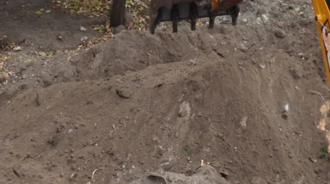 A backhoe tractor works on a construction site. Stock Footage 55705366