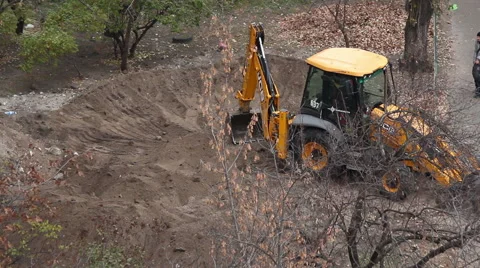 Backhoe tractor works on a construction site. Stock Footage 55706549