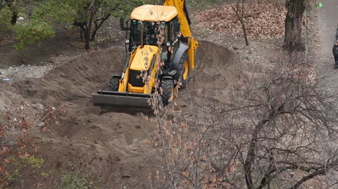 Backhoe tractor works on a construction site. Video stock 55706581