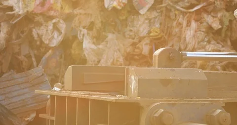 Backhoe use electromagnets crane keeping garbage compactor. Stock Footage 118213138