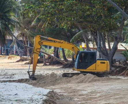 Backhoe working on beach 스톡 사진