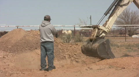 Backhoe Working with Man Watching Stock Footage 548809