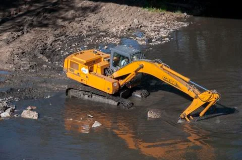 Backhoe working in the River Bernesga Stock Photos