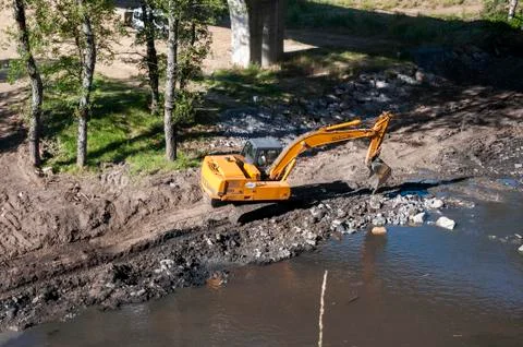 Backhoe working in the River Bernesga Stock Photos