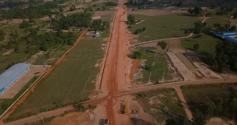 Backing up by drone above construction road between forest wood Stock Footage 109077691