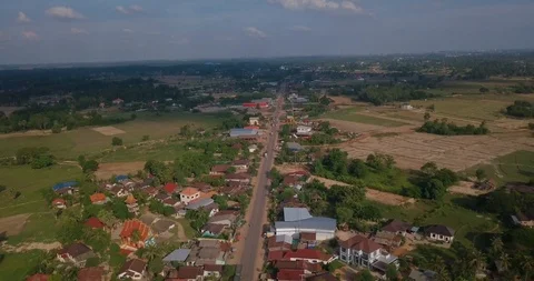 Backing up with drone above road with traffic and panorama of Vientiane province Stock Footage 109078228