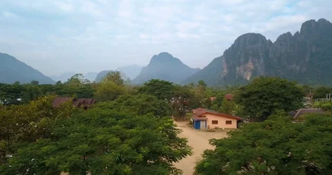 Backing up over bridge in Vang Vieng, Laos, boat under and car Stock Footage 108474839