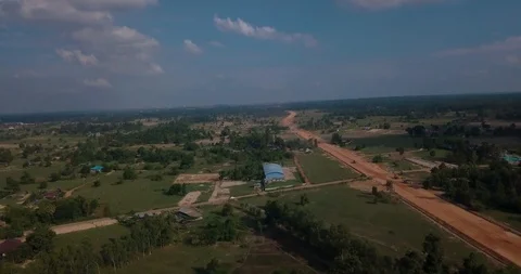 Backing up past broken road above forest in fields with opening view of horizon Stock Footage 109077430