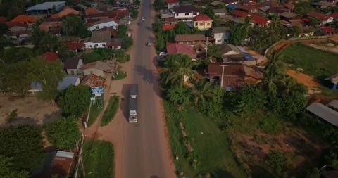 Backing up right above road with huge truck coming towards in a village Stock Footage 109078488